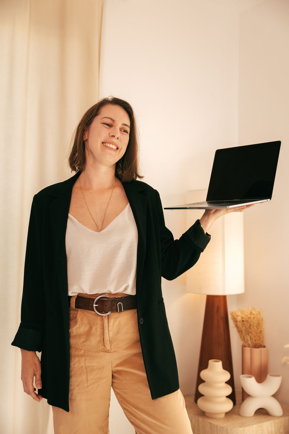 Gwendoline Meyer, souriante, tient un ordinateur portable ouvert